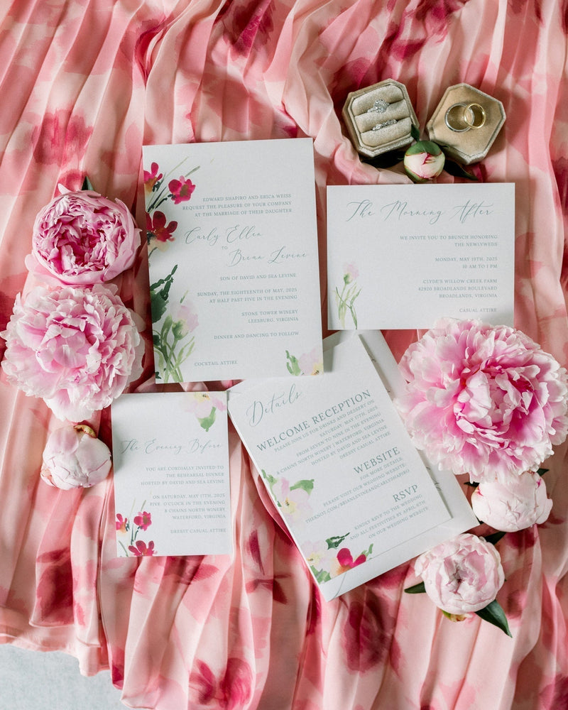 Flatlay of a floral wedding invitation from Invited by LamaWorks