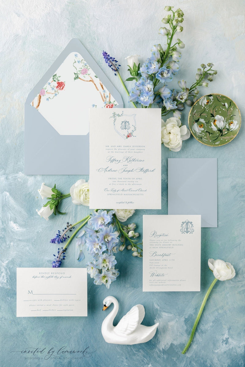 Flatlay of the Tiffany wedding invitation suite from Invited by LamaWorks