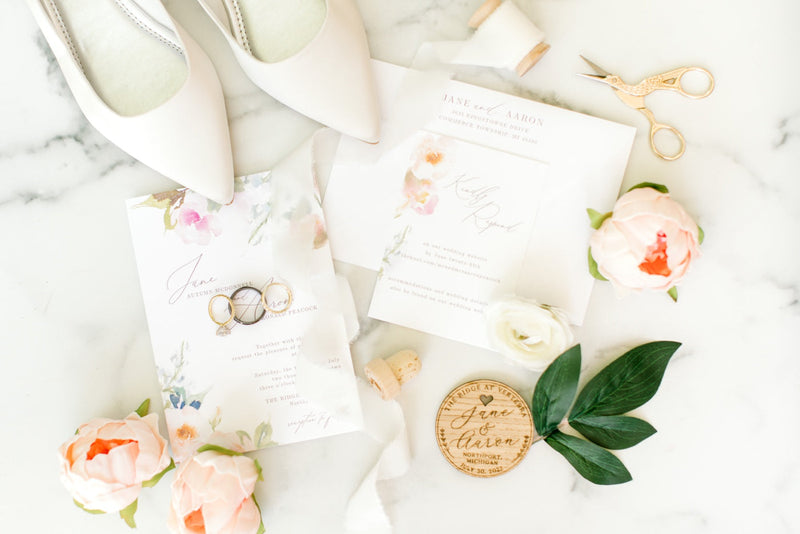 A summer wedding invitation suite with blue and pink florals from Invited by LamaWorks
