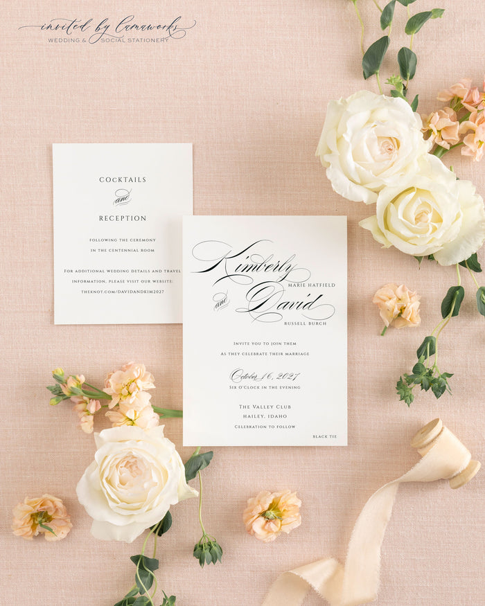 Cream wedding invitation envelope with hand-calligraphed return address next to the Kim - Classic Calligraphy invitation card