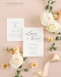 Cream wedding invitation envelope with hand-calligraphed return address next to the Kim - Classic Calligraphy invitation card