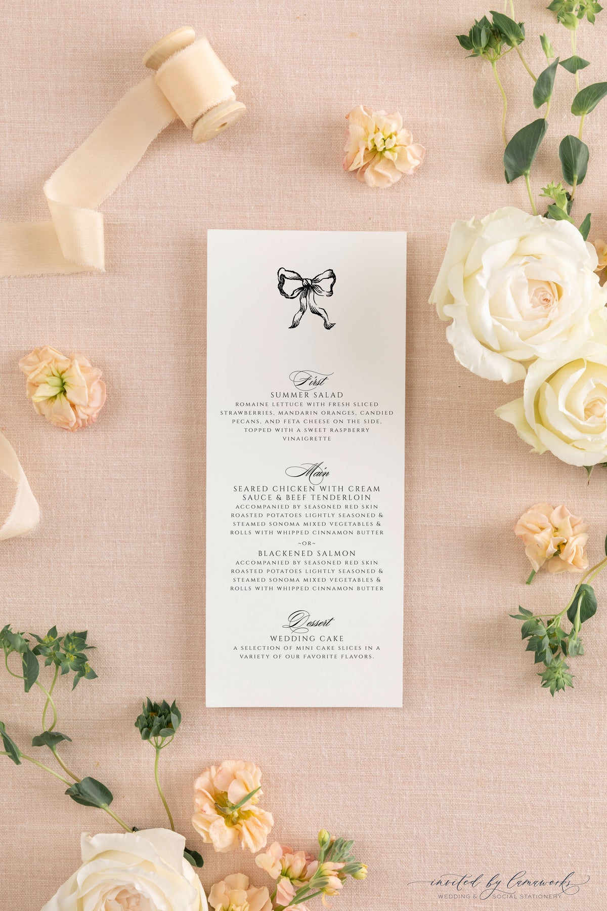 The Kim collection wedding menu card featuring a hand-illustrated bow, calligraphy course headers, and clean serif menu details, styled with ribbon and garden roses