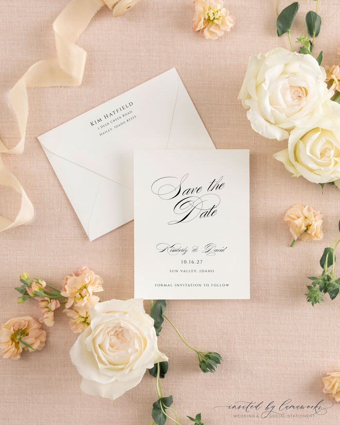 The Kim collection calligraphy save the date card in black ink, paired with a cream envelope and calligraphy return address