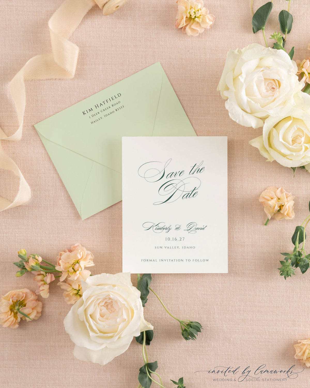 The Kim collection calligraphy save the date card in sage green ink, paired with a matching sage envelope