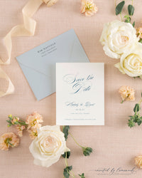 The Kim collection calligraphy save the date card in blue ink, paired with a matching dusty blue envelope