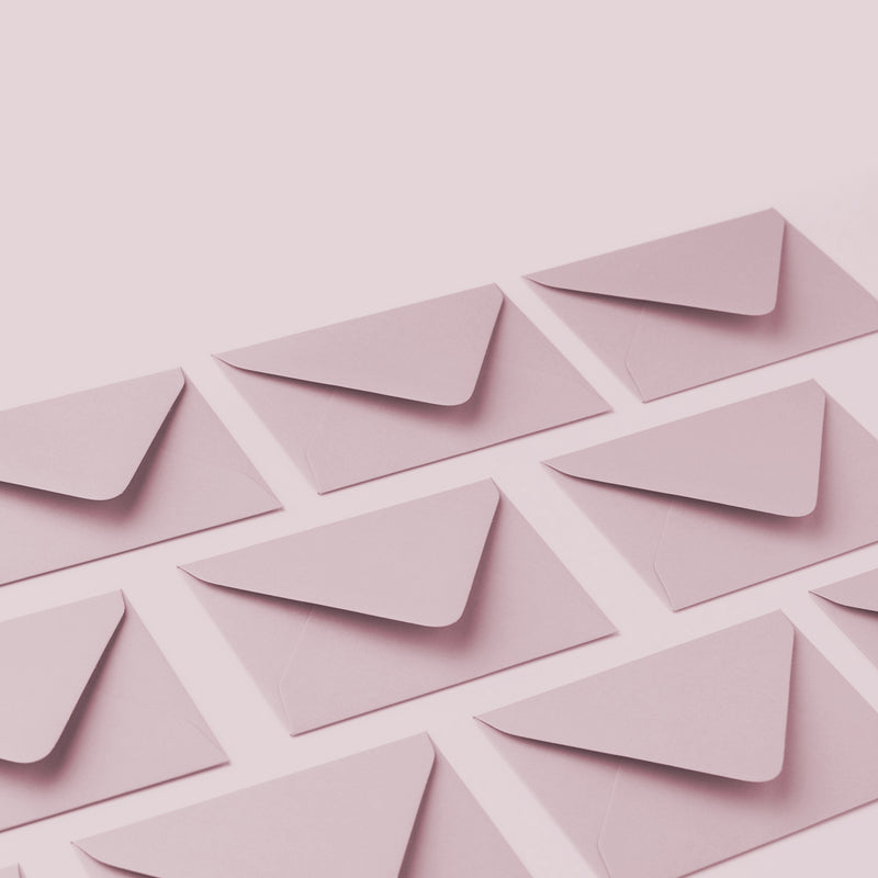 a collection of dusty pink envelopes