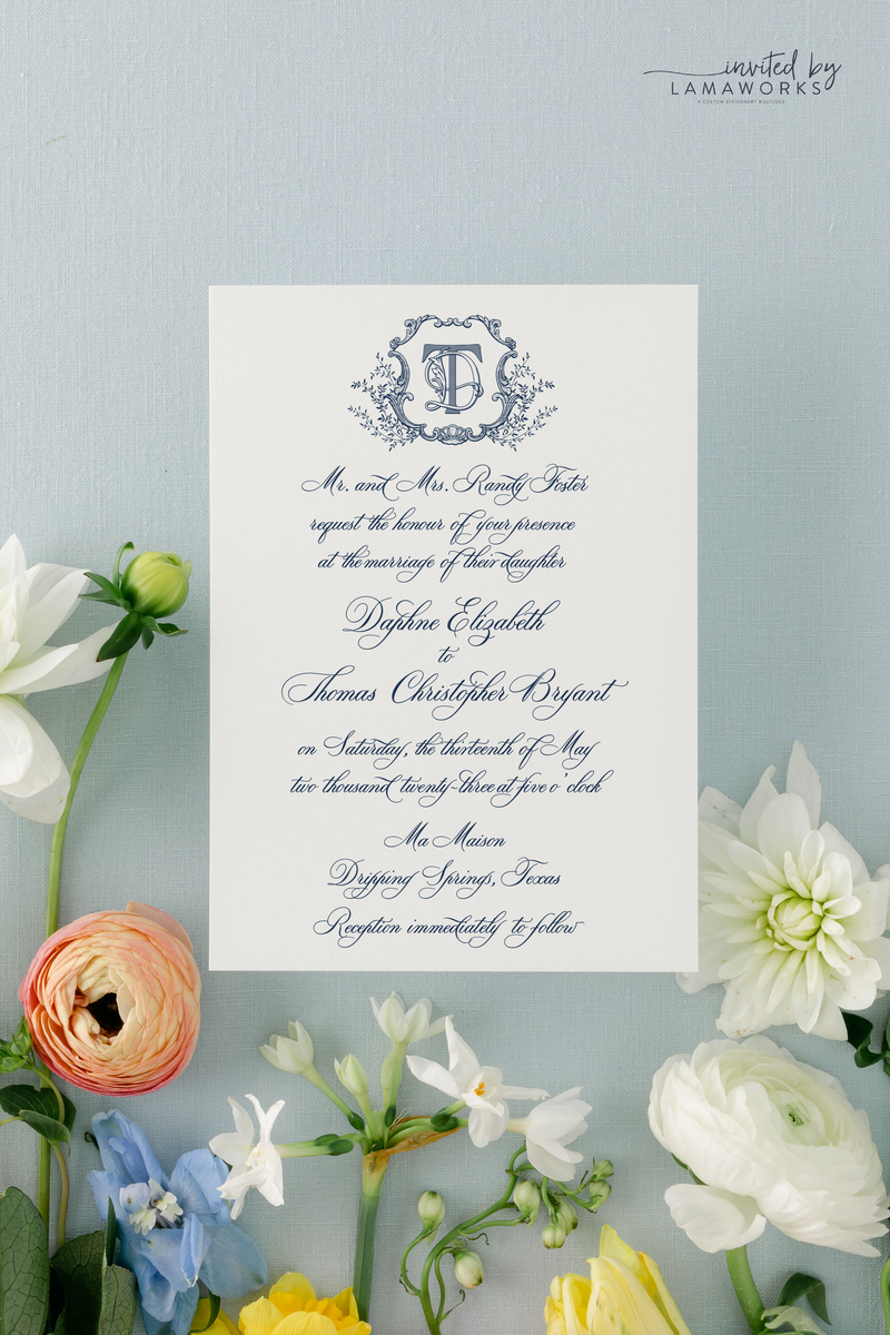 Classic and traditional wedding invitation all in calligraphy with a monogram crest