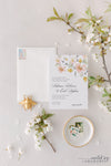 Elegant spring floral wedding invitation in peach and yellow.